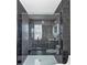 Bathroom with modern walk-in shower with black marble tile and glass doors at 3690 Darrah Sw Way, Atlanta, GA 30331