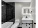 Stylish bathroom featuring black tile accent wall and a vanity with storage at 3690 Darrah Sw Way, Atlanta, GA 30331
