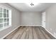 A bright bedroom with wood-look flooring and a large window at 3690 Darrah Sw Way, Atlanta, GA 30331