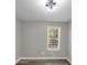 Well-lit bedroom with hardwood floors, a modern light fixture, and a window at 3690 Darrah Sw Way, Atlanta, GA 30331