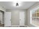Bedroom featuring modern light fixture, window, and two closets at 3690 Darrah Sw Way, Atlanta, GA 30331