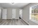 Bedroom with wood-look flooring, large windows, and white trim at 3690 Darrah Sw Way, Atlanta, GA 30331