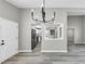 Dining area with a view to a modern kitchen with stainless steel appliances and white cabinetry at 3690 Darrah Sw Way, Atlanta, GA 30331