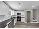 Modern kitchen featuring granite countertops, white cabinets, and stainless steel appliances at 3690 Darrah Sw Way, Atlanta, GA 30331
