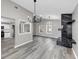 Open-concept living area with views to kitchen and fireplace, with modern lighting and lots of natural light at 3690 Darrah Sw Way, Atlanta, GA 30331