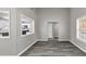 Open-concept living room with gray floors, bright walls, and a glimpse into the well-lit kitchen at 3690 Darrah Sw Way, Atlanta, GA 30331