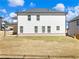 Spacious backyard featuring a level lawn and a modern two-story home with white siding and dark trim at 4035 Hosch Retreat Dr, Buford, GA 30519