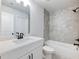 Bathroom featuring modern vanity, shower-tub combo, and tile surround at 4035 Hosch Retreat Dr, Buford, GA 30519