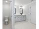 Modern bathroom with dual sinks, sleek gray cabinets and black hardware at 4035 Hosch Retreat Dr, Buford, GA 30519
