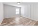 Bright bedroom with modern plank floors and custom trim accent wall at 4035 Hosch Retreat Dr, Buford, GA 30519