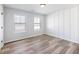 Bedroom featuring plank floors, neutral walls and natural light from two windows at 4035 Hosch Retreat Dr, Buford, GA 30519