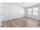 Bedroom with wood-look floors, modern wainscoting and lots of natural light at 4035 Hosch Retreat Dr, Buford, GA 30519