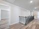 Bright hallway featuring stylish railings, and access to multiple rooms at 4035 Hosch Retreat Dr, Buford, GA 30519