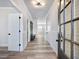 Bright hallway features wood-look floors, white trim, and stylish lighting fixtures at 4035 Hosch Retreat Dr, Buford, GA 30519