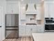 Close up view of a stainless steel refrigerator, gas range, oven, and white countertops at 4035 Hosch Retreat Dr, Buford, GA 30519