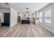 Open kitchen and dining area featuring a center island, stainless steel appliances, and wood-look floors at 4035 Hosch Retreat Dr, Buford, GA 30519