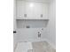 Laundry room featuring bright white cabinets and tile flooring at 4035 Hosch Retreat Dr, Buford, GA 30519