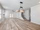 Spacious living room with modern lighting, a staircase, and a fireplace at 4035 Hosch Retreat Dr, Buford, GA 30519