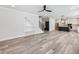 Open living space with fireplace, built-in shelving, stairs, and view into the kitchen at 4035 Hosch Retreat Dr, Buford, GA 30519