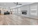 Open living space with modern fireplace, adjacent kitchen, and plenty of natural light at 4035 Hosch Retreat Dr, Buford, GA 30519