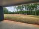 Covered patio with a view of the expansive backyard with trees at 476 Benson Meadows Dr, Dallas, GA 30157