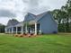 Beautiful blue home with a well-maintained lawn and manicured landscaping on a spacious lot at 476 Benson Meadows Dr, Dallas, GA 30157