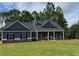 Charming single-story home with a welcoming front porch and a lush green lawn at 476 Benson Meadows Dr, Dallas, GA 30157