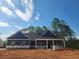 Charming new construction home with a covered front porch and craftsman-style details at 476 Benson Meadows Dr, Dallas, GA 30157