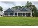 Charming single-story home with blue siding, a welcoming front porch, and a well-manicured lawn at 476 Benson Meadows Dr, Dallas, GA 30157