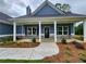 Inviting front porch with stone accents, landscaping, and a stylish entry door on a blue home at 476 Benson Meadows Dr, Dallas, GA 30157