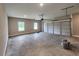 Spacious garage with a large overhead door, concrete floor, and windows for natural light at 476 Benson Meadows Dr, Dallas, GA 30157