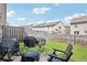 A cozy backyard with a lush lawn, privacy fence, and outdoor seating area, perfect for relaxing and entertaining at 7554 Roseberry Way, Lithonia, GA 30038