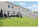 Green backyard featuring a patio with seating, a grill, and a well-maintained lawn at 7554 Roseberry Way, Lithonia, GA 30038