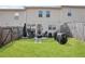 Large, well-kept backyard with a grassy area, a small patio with seating, and a wood fence at 7554 Roseberry Way, Lithonia, GA 30038