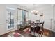 Charming dining room featuring hardwood floors, a modern chandelier, and plenty of natural light at 7554 Roseberry Way, Lithonia, GA 30038
