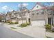 Beautiful townhomes featuring brick and siding exteriors, attached garages, and well-manicured landscaping at 7554 Roseberry Way, Lithonia, GA 30038