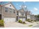 Charming townhome community featuring well-maintained landscaping and attached two-car garages at 7554 Roseberry Way, Lithonia, GA 30038