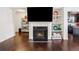 Cozy living room showcasing a fireplace, hardwood floors, and custom built-in shelving at 7554 Roseberry Way, Lithonia, GA 30038