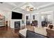 Open-concept living room featuring fireplace, coffered ceilings, hardwood floors, and neutral color palette at 7554 Roseberry Way, Lithonia, GA 30038
