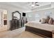 Bright main bedroom featuring a ceiling fan and a large dresser at 7554 Roseberry Way, Lithonia, GA 30038
