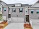 Charming townhome with a gray brick facade, two-car garage, and manicured landscaping at 1347 Fern Ridge Ct # 29, Norcross, GA 30093