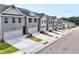 Charming street view of new townhomes, each with a private garage and landscaped front yards at 1347 Fern Ridge Ct # 29, Norcross, GA 30093