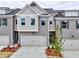Charming townhome featuring a two-car garage, gray brick facade, and craftsman-style accents at 1357 Fern Ridge Ct # 30, Norcross, GA 30093