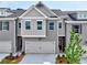 Stylish two-story townhome featuring a gray brick facade, attached garage, and inviting front entrance at 1357 Fern Ridge Ct # 30, Norcross, GA 30093