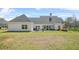 Expansive backyard with a covered patio, complemented by lush green grass and a play set at 20 Tuscany Dr, Mansfield, GA 30055