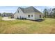 Spacious backyard featuring a well-maintained lawn and a charming white house with a two-car garage at 20 Tuscany Dr, Mansfield, GA 30055