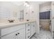 Bright bathroom featuring double sink vanity with white cabinets, quartz countertops, and marble tile floors at 20 Tuscany Dr, Mansfield, GA 30055