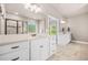 Bright bathroom with a white double vanity, quartz counters, large framed mirror, tile floors, and shower at 20 Tuscany Dr, Mansfield, GA 30055