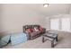 Bonus room featuring neutral walls, carpet, a comfortable sofa, with ample seating and entertainment space at 20 Tuscany Dr, Mansfield, GA 30055