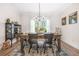 Dining room featuring a rustic wooden table, elegant chandelier, and neutral decor at 20 Tuscany Dr, Mansfield, GA 30055